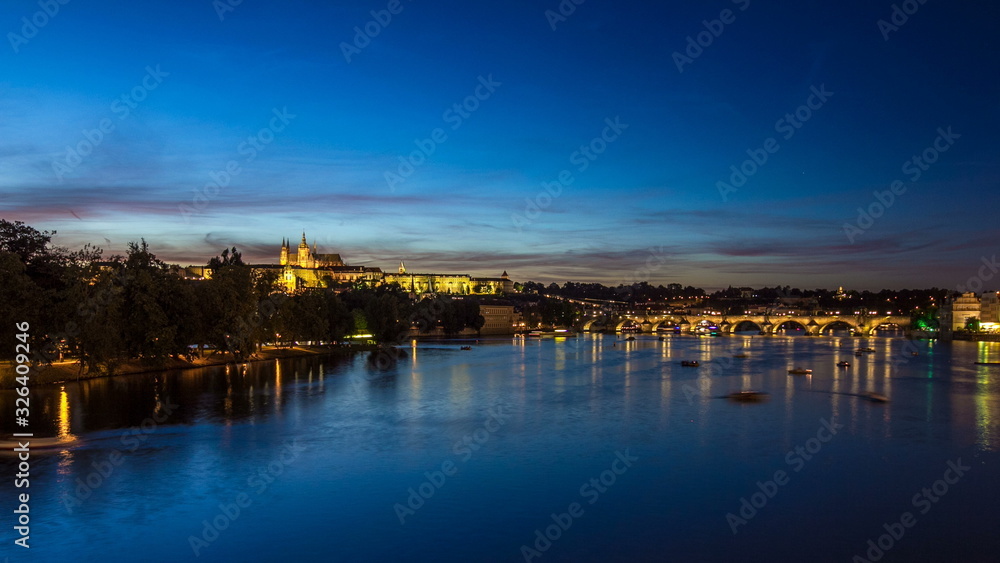 View of the city Prague in Czech Republic with colorful paddle boats day to night timelapse on the Vltava river with beautiful sky