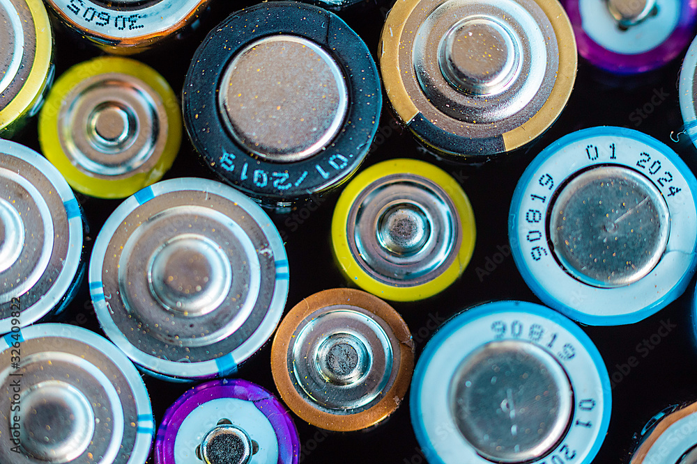 Macro of spent colored batteries. Recycling process concept. Macro of spent colored batteries. Recycling process concept.