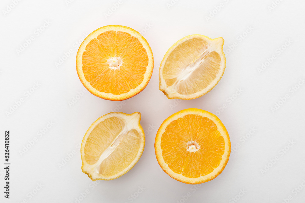Top view of orange and lemon halves on white background Top view of orange and lemon halves on white background