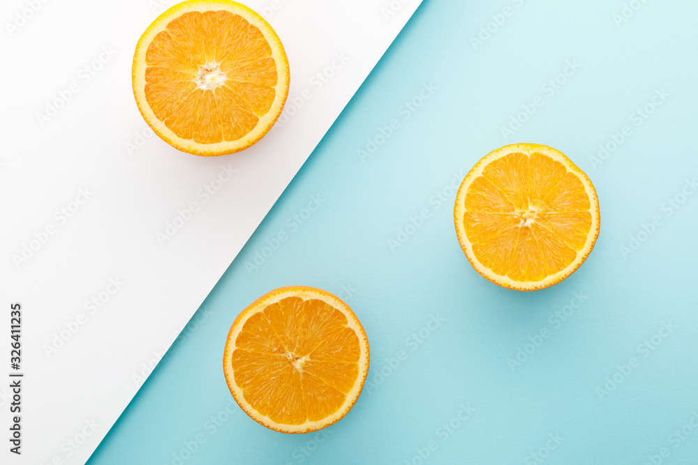 Top view of oranges halves on white and blue background Top view of oranges halves on white and blue background
