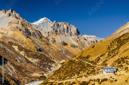 Ledar (Chuli Ledar) village in Himalaya mountains with Thorung peak on the horizon in autumn sunny day. Annapurna Circuit trek, Nepal. photo