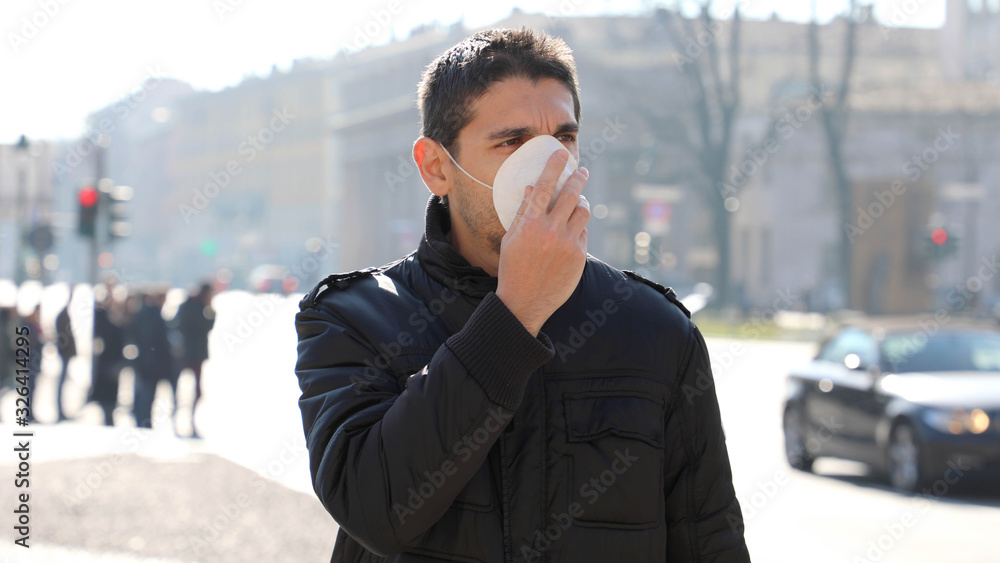 COVID-19 Pandemic Coronavirus Man in city street wearing face mask protective for spreading of Coronavirus Disease 2019. Portrait of man with face mask against SARS-CoV-2. COVID-19 Pandemic Coronavirus Man in city street wearing face mask protective for spreading of Coronavirus Disease 2019. Portrait of man with face mask against SARS-CoV-2.