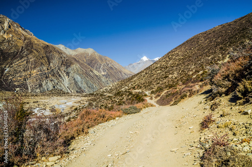 Trekking route from Manang village to Torung La in autumn sunny day. Annapurna circuit trek, Nepal.
