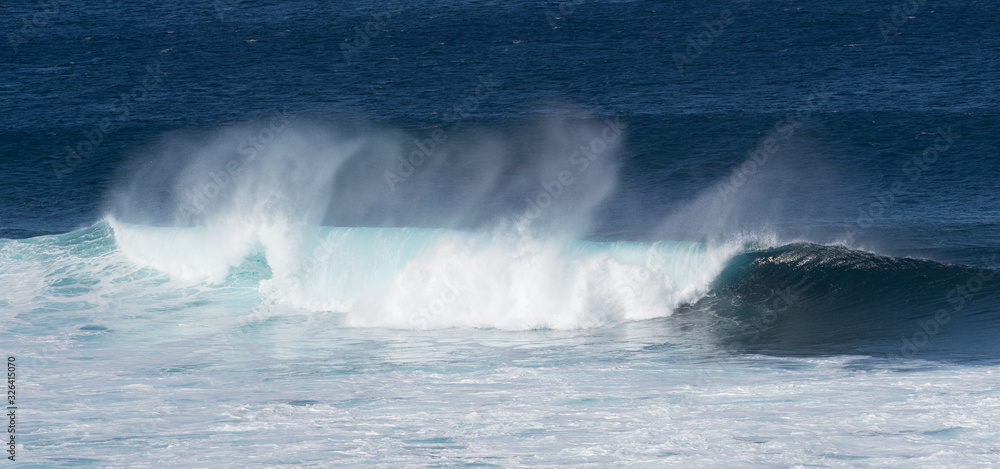 Dramatic white surf and spray as turquoise blue ocean waves roll Dramatic white surf and spray as turquoise blue ocean waves roll
