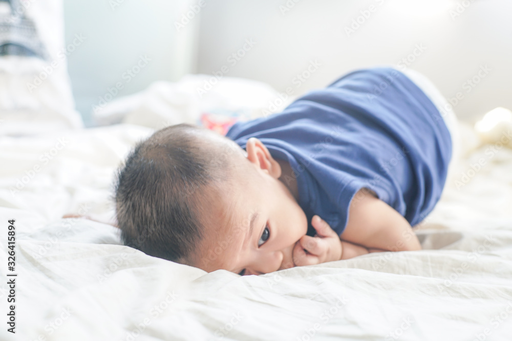 Adorable 6 month baby boy lying  on white blanket sleeping boy