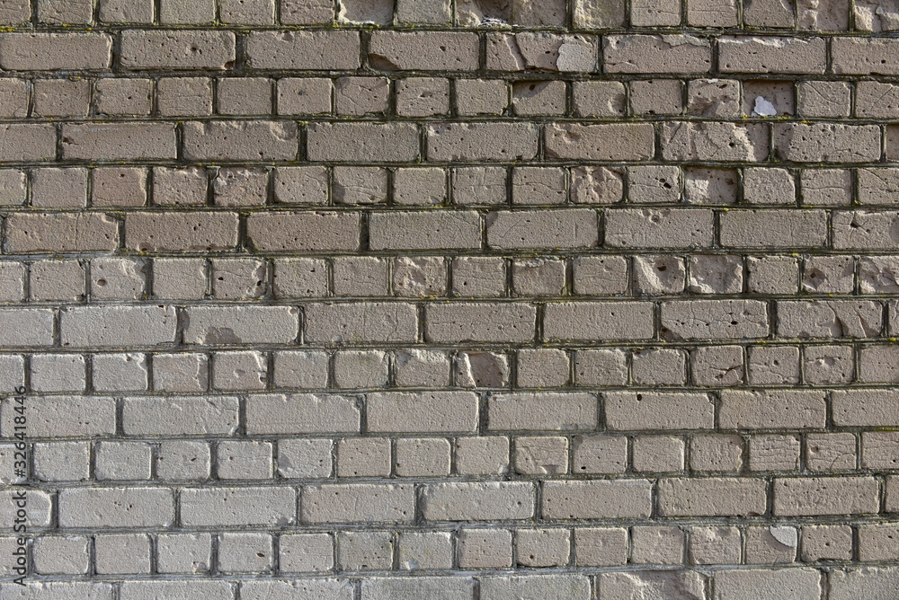 Old shabby, wrecked brick wall with grey cement mortar as background Old shabby, wrecked brick wall with grey cement mortar as background