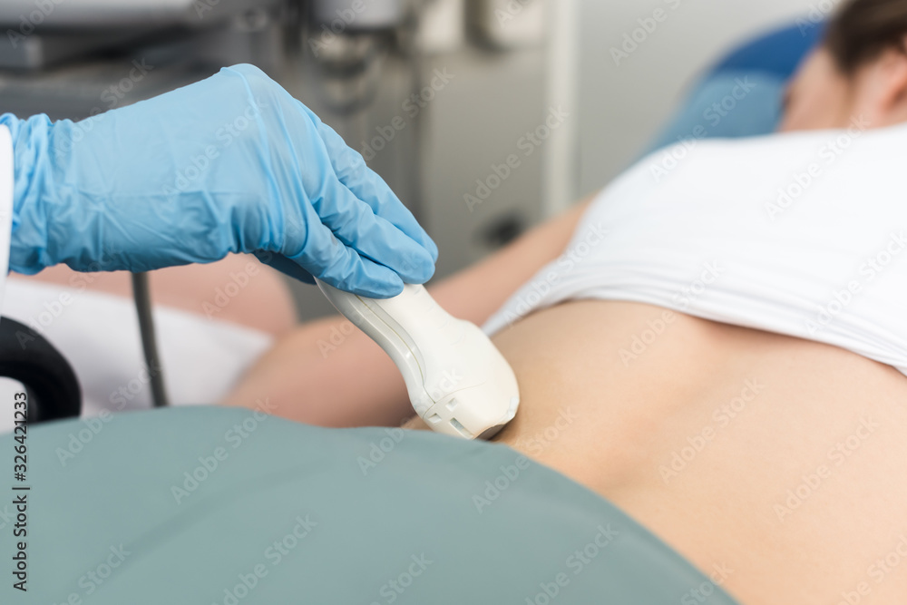 Fototapeta premium cropped view of doctor examining kidney with ultrasound scan