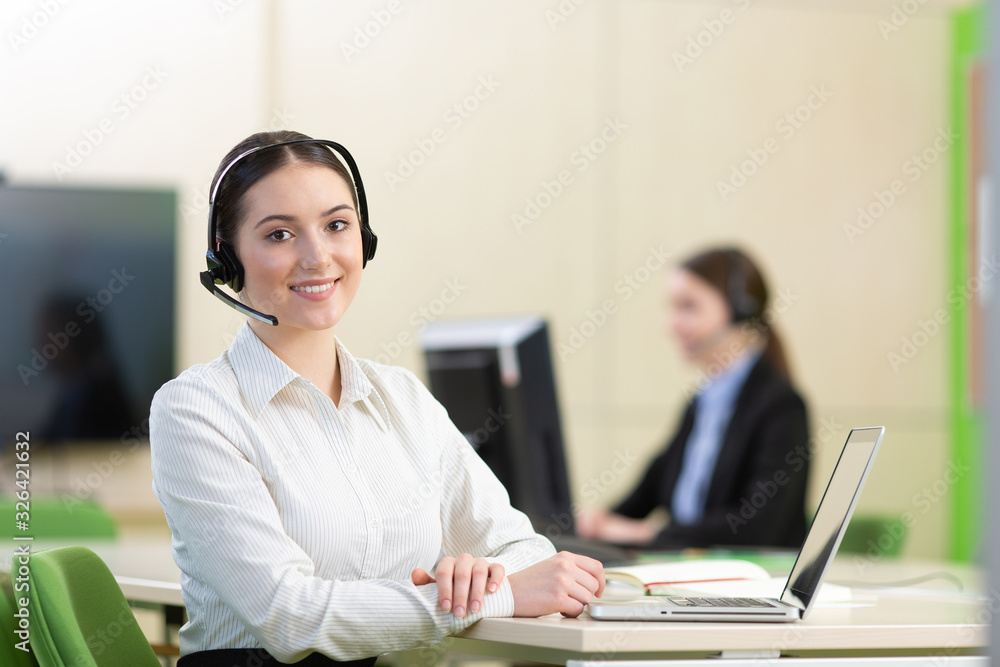 Young, confident and smiling customer support operator.. Young, confident and smiling customer support operator..