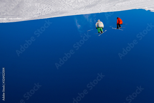 Abstract ski background with skiers in mid air, upside down.