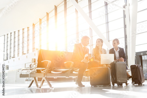 Business people working while waiting for boarding in the airport photo