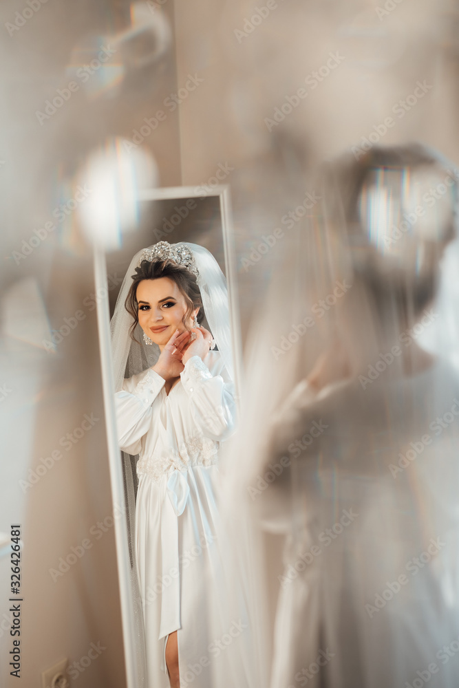 eautiful bride near mirrror. Fashion photo of beautiful bride posing in room eautiful bride near mirrror. Fashion photo of beautiful bride posing in room