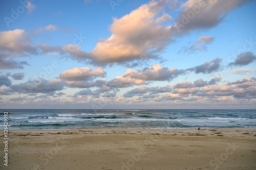 Colorful sky with clouds on horinzon at the beach in evening