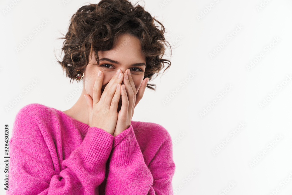 Image of joyful beautiful woman smiling and covering her face Image of joyful beautiful woman smiling and covering her face