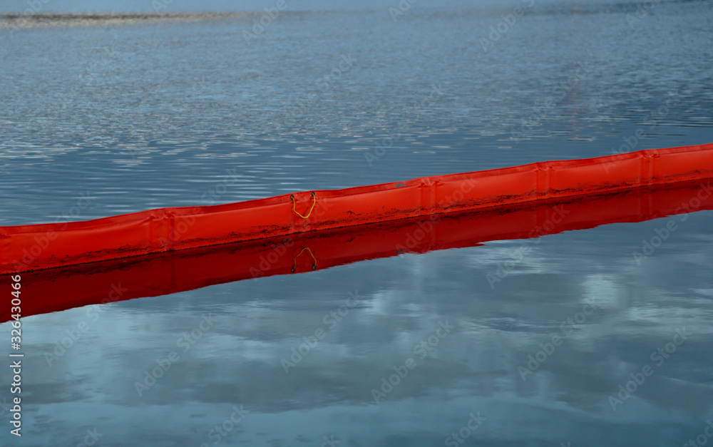 The oil boom prevents the oil damage from expanding on the lake The oil boom prevents the oil damage from expanding on the lake