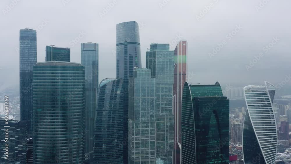 Aerial drone shot flying over center of Moscow city buildings, skyscrapers at cloudy winter day. Drone shot flying over Moscow skyscrapers. Aerial drone shot flying over center of Moscow city buildings, skyscrapers at cloudy winter day. Drone shot flying over Moscow skyscrapers.