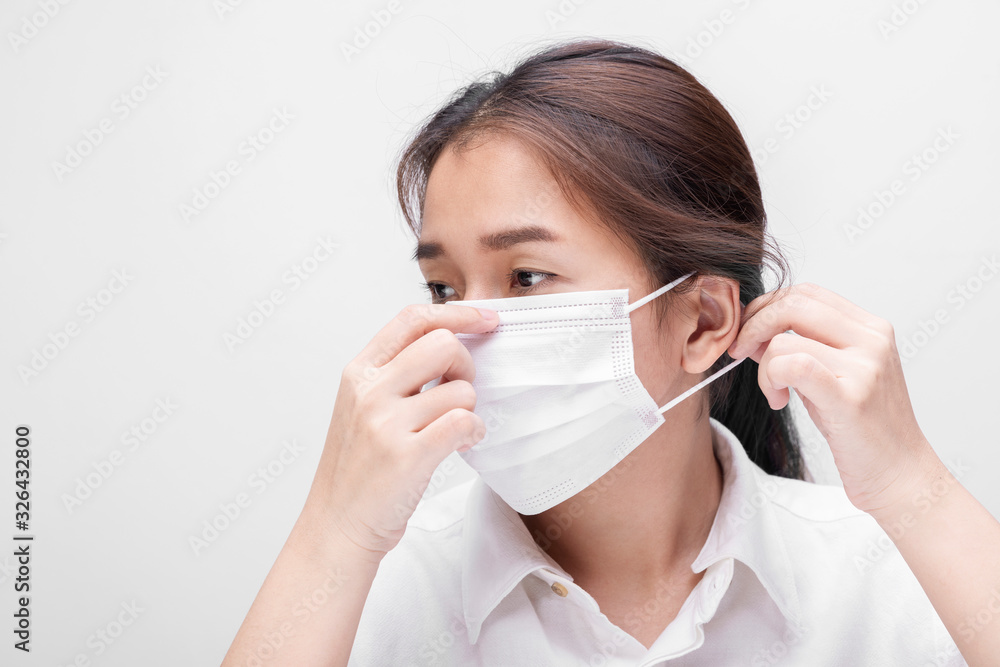 Young woman with face mask isolated on white background to prevent coronavirus & PM 2.5 air pollution, Woman demonstrate how to wear virus protective face mask. Young woman with face mask isolated on white background to prevent coronavirus & PM 2.5 air pollution, Woman demonstrate how to wear virus protective face mask.