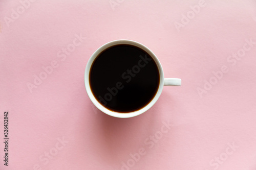 One small cup of coffee on pink background