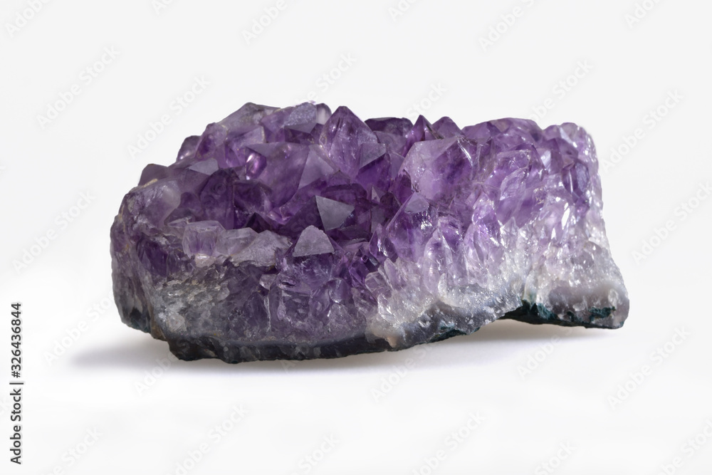 Small amethyst cargo with polyhedral crystals on a contrasting white background Small amethyst cargo with polyhedral crystals on a contrasting white background