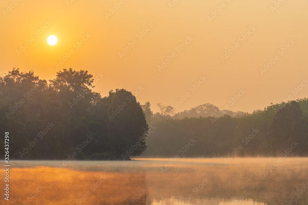 Scenic View Of Lake Against Sky During Sunrise. Steam floating above the water surface. Scenic View Of Lake Against Sky During Sunrise. Steam floating above the water surface.
