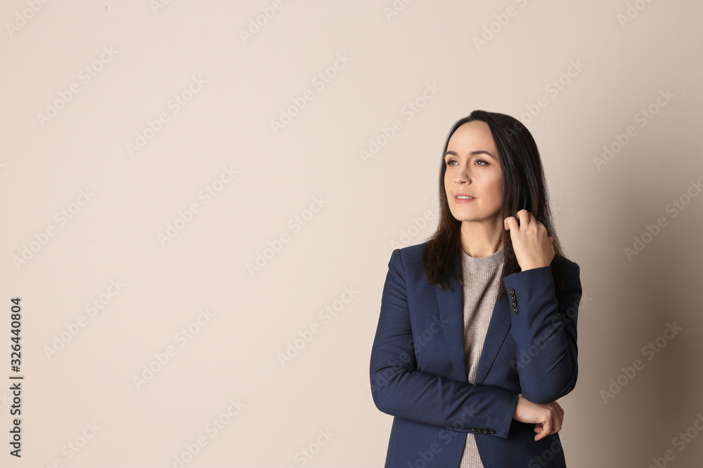 Portrait of beautiful mature woman on beige background. Space for text Portrait of beautiful mature woman on beige background. Space for text