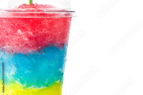 Bild auf Leinwand Colorful slushie of differents flavors with straw in plastic cup isolated on white background