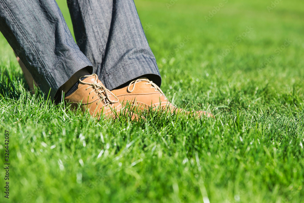 Close up of businessman foot on the grass Close up of businessman foot on the grass