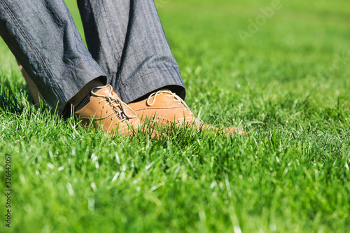 Close up of businessman foot on the grass