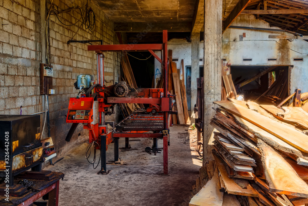 sawn boards and sawing machines, Asian sawmill on the background of a tropical forest. Sri lanka.