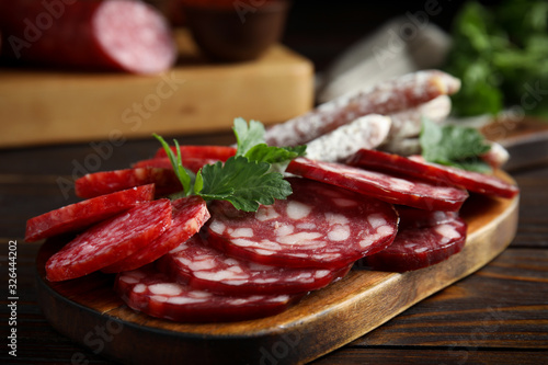 Different types of sausages served on wooden table, closeup