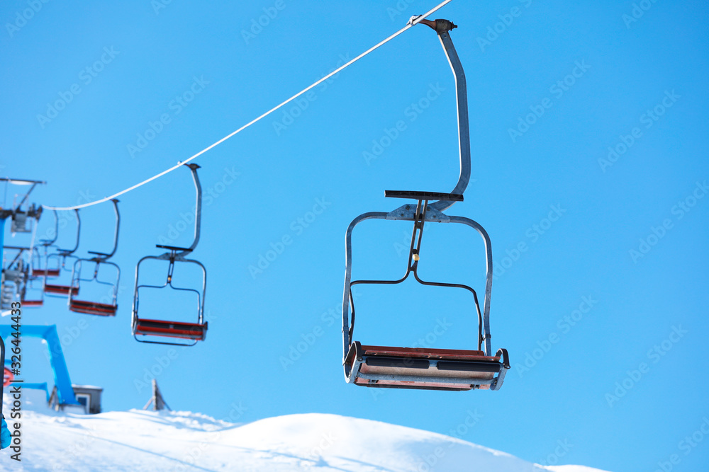 Empty chairlift at mountain ski resort. Winter vacation Empty chairlift at mountain ski resort. Winter vacation