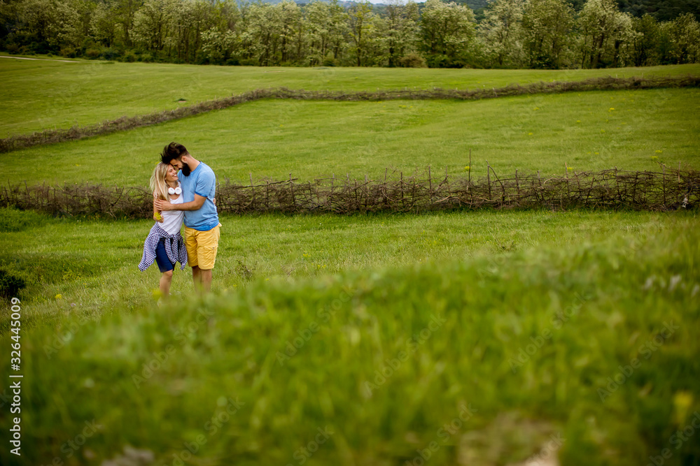 Loving couple enjoying a walk through grass land