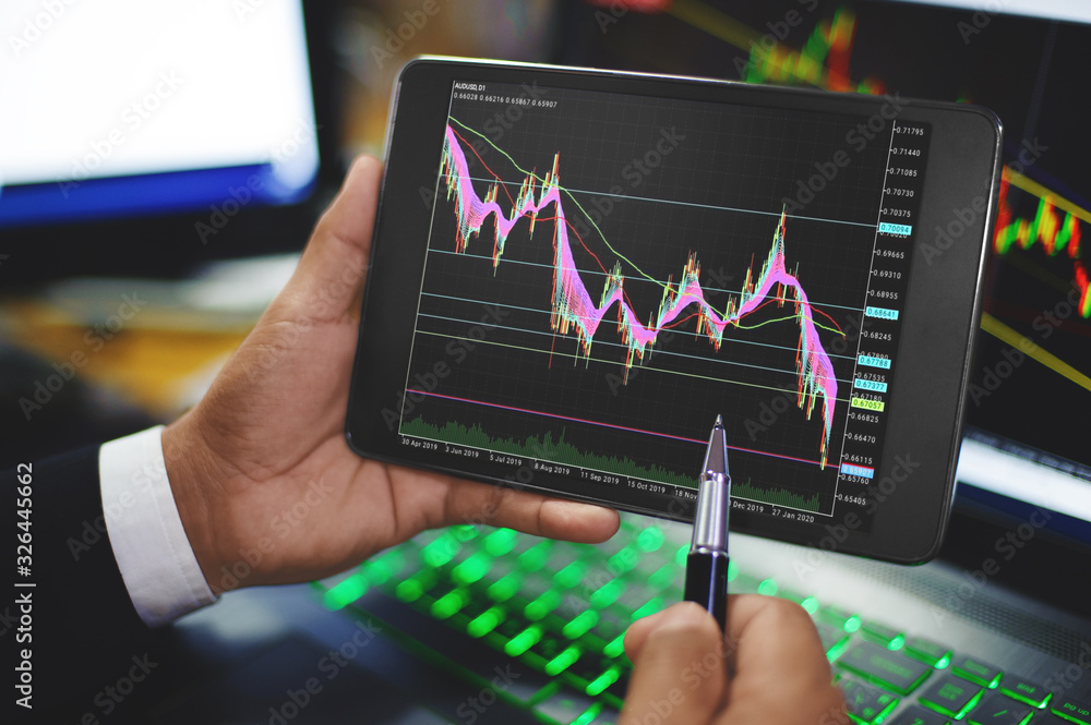 Businessman trading stock marketing and checking forex trading graph chart  on tablet and laptop Stock-Foto | Adobe Stock