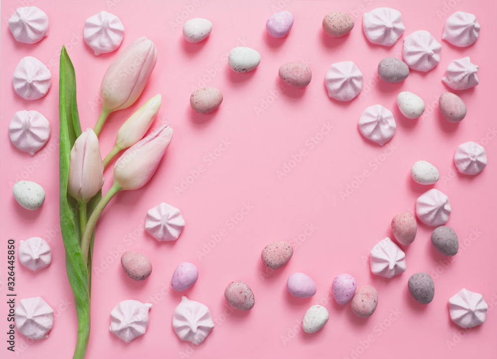 Pink pastel Easter with delicate tulips, sweet meringues and sugar-coated chocolate eggs.
