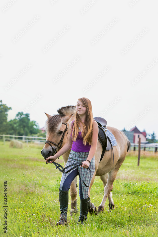 Portrait of young beautiful woman standing with horse in ranch Portrait of young beautiful woman standing with horse in ranch