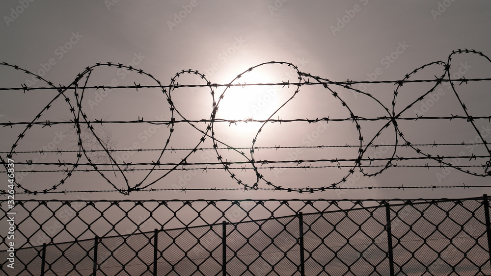 Barbed wire fence against the sun Barbed wire fence against the sun