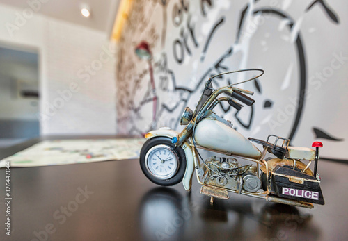 Close up photo of motorbike toy clock on table