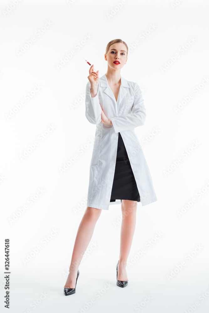 sexy nurse in white coat standing with syringe on white sexy nurse in white coat standing with syringe on white