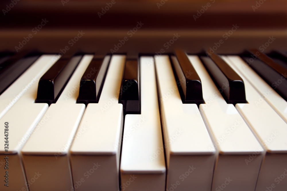 Detail of a piano keyboard with one key (b) pressed