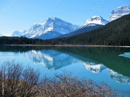 Snowcapped mountains reflected on a lake in the mountains