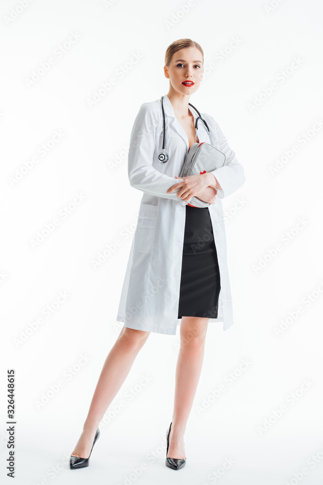 beautiful and sexy nurse holding first aid kit on white beautiful and sexy nurse holding first aid kit on white