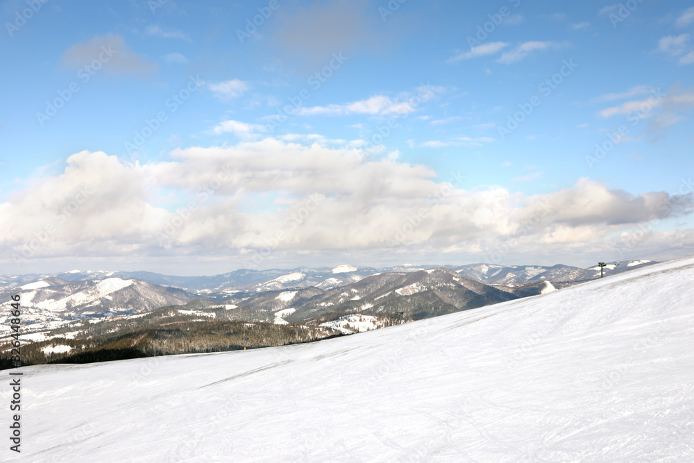 Picturesque mountain landscape with snowy hills in winter