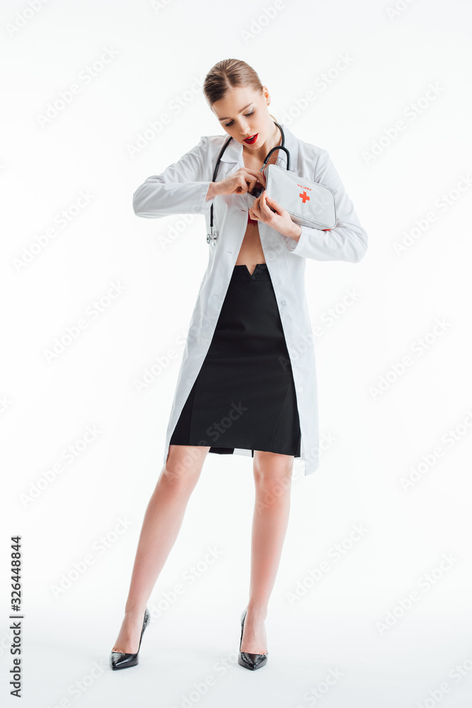 attractive and sexy nurse holding first aid kit on white attractive and sexy nurse holding first aid kit on white