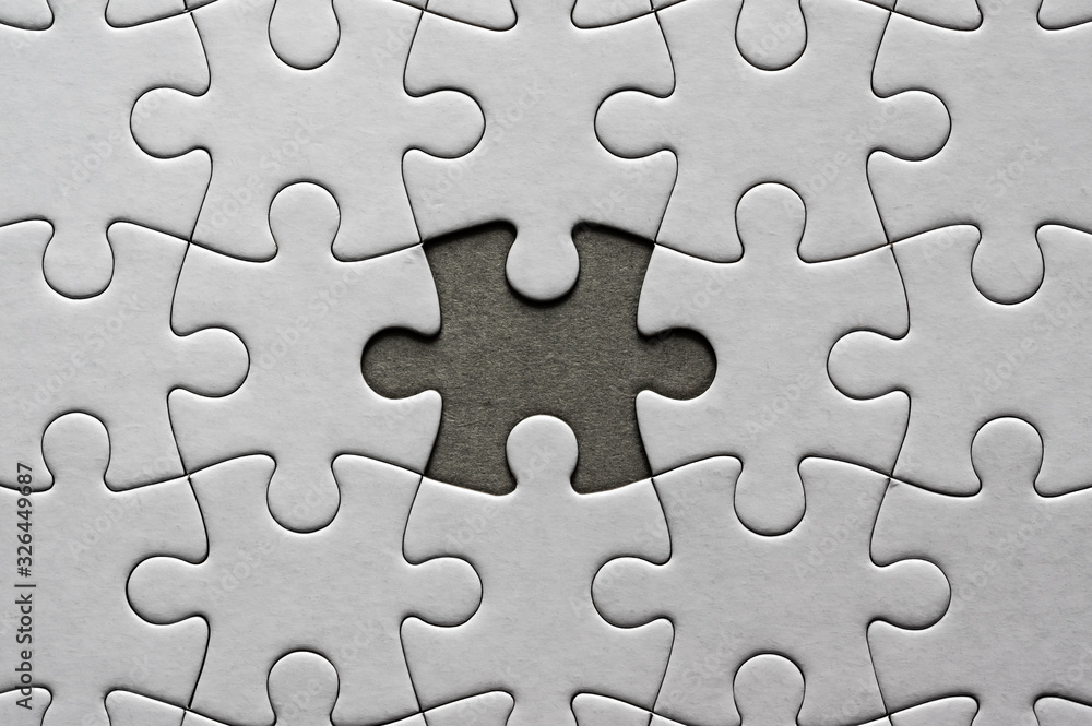 Blank, white jigsaw puzzle close up. One piece is missing Blank, white jigsaw puzzle close up. One piece is missing