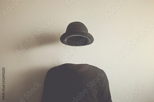 invisible man wearing black bowler, surreal concept of absence of identity photo