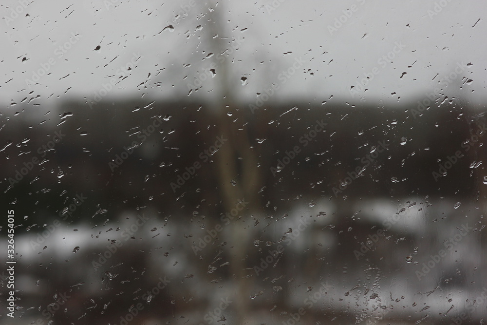 raindrops on the window on a blurred background of inclement weather raindrops on the window on a blurred background of inclement weather