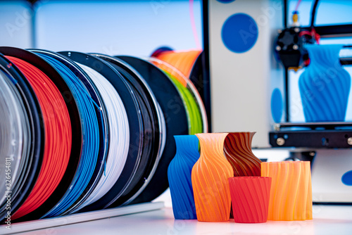 3D Printer Plastic filament for 3D printer and printed products in the interior of the design office photo