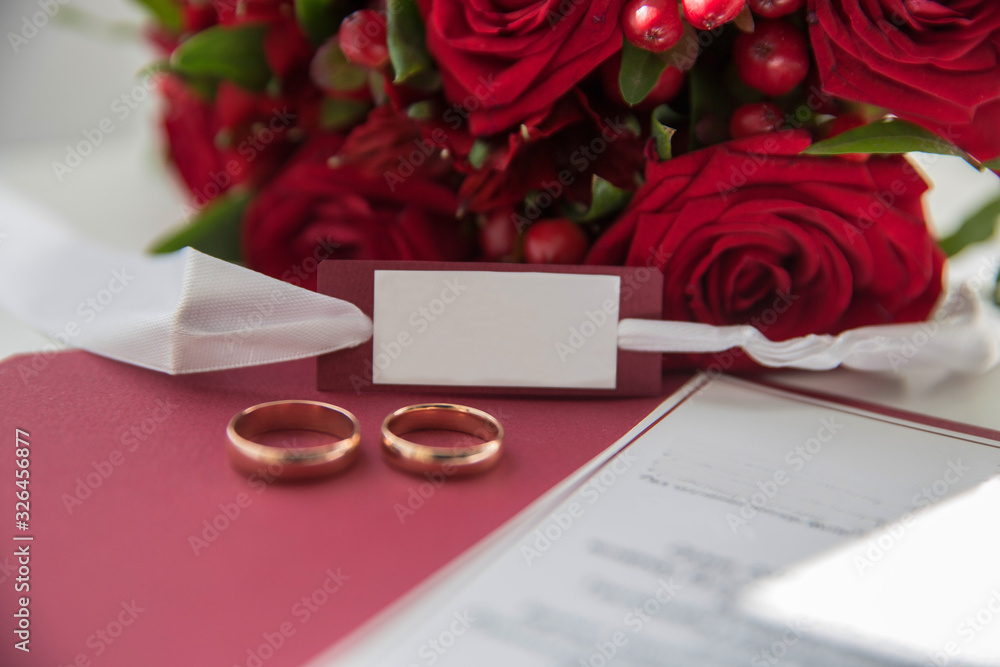wedding rings on the background of a bouquet of roses wedding rings on the background of a bouquet of roses