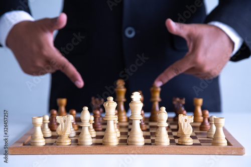  Businessman leadership hand moving of playing chess concept: symbol confident new strategy plan for win and success, sports game thinking battle planning object achievement queen for successful