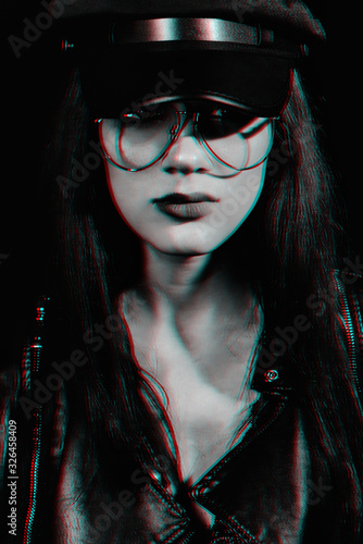 Fototapeta stylish portrait of a young girl with glasses in a leather jacket and cap
