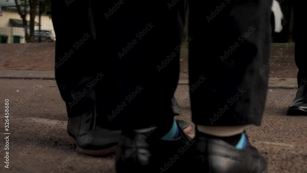 Several men's dress shoes and fun socks on the street Several men's dress shoes and fun socks on the street